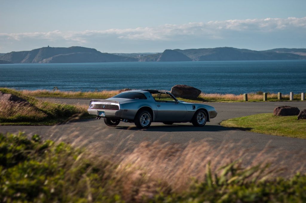 A car parked by a lake.