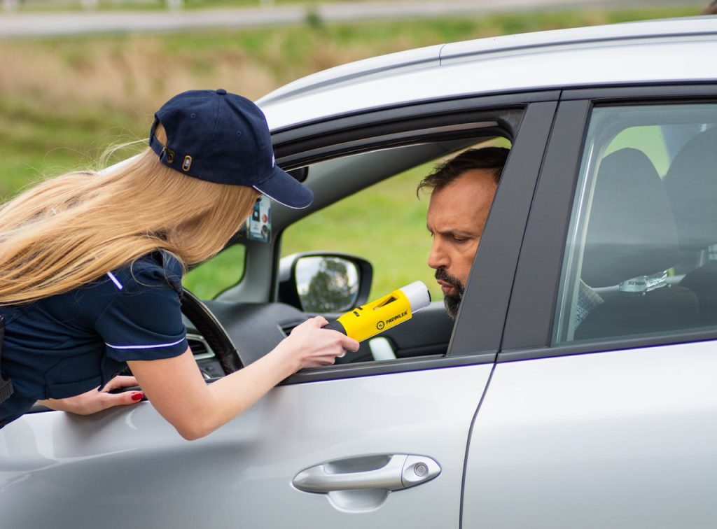 A police officer conducting a DUI check on a driver.